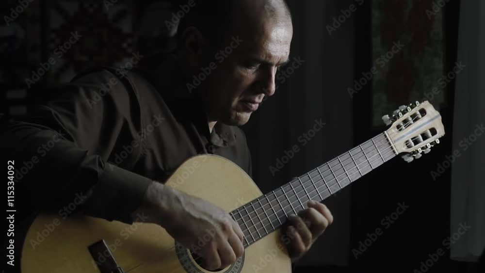 Man masterfully plays on classical acoustic guitar