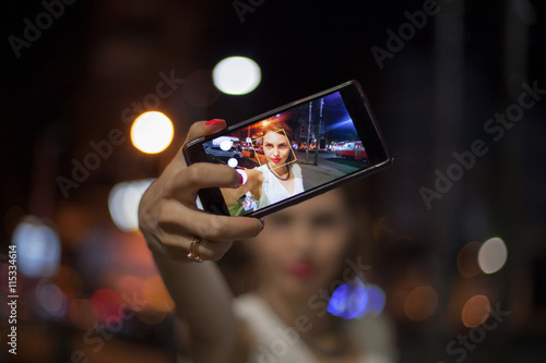 Young woman taking selfie in the city