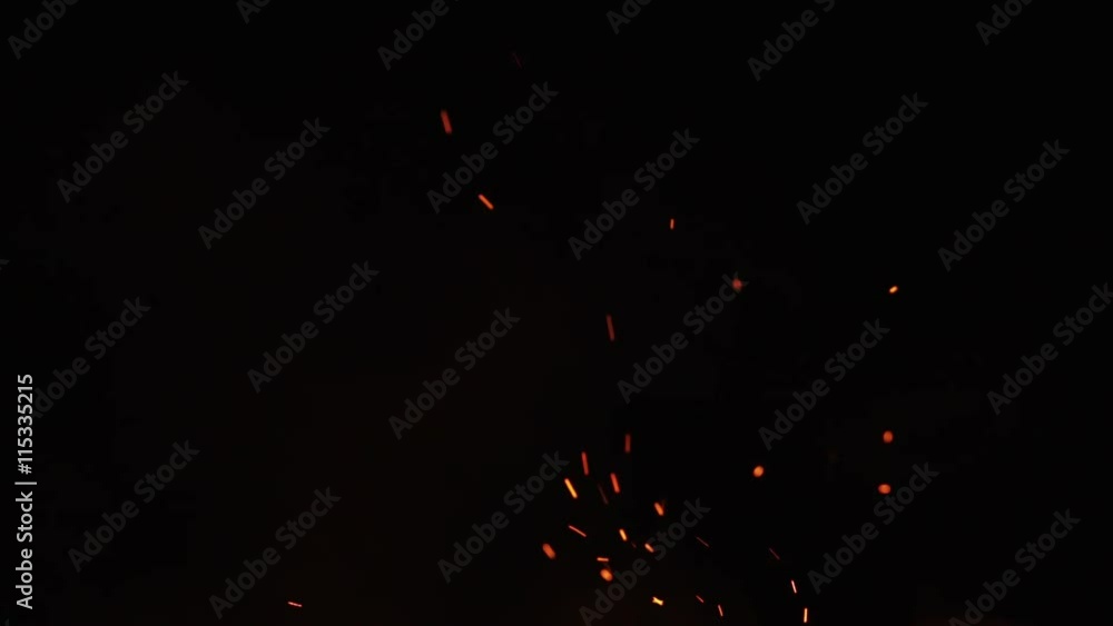 fire sparks from campfire over black background