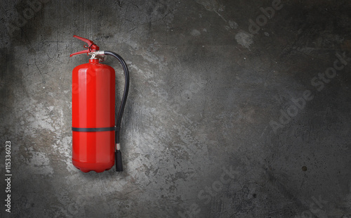fire extinguisher on gray wall photo