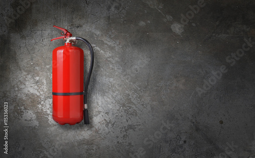 fire extinguisher on gray wall