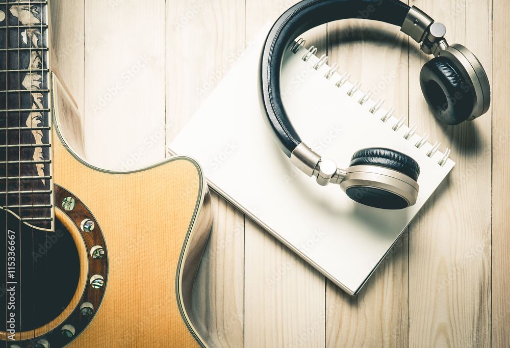 Fototapeta premium Blank note book binder with Golden music headphone and guitar for song writing.