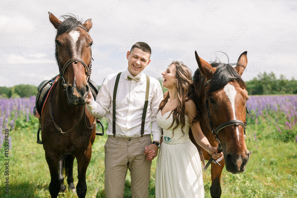 Happy wedding couple with horses Happy wedding couple with horses