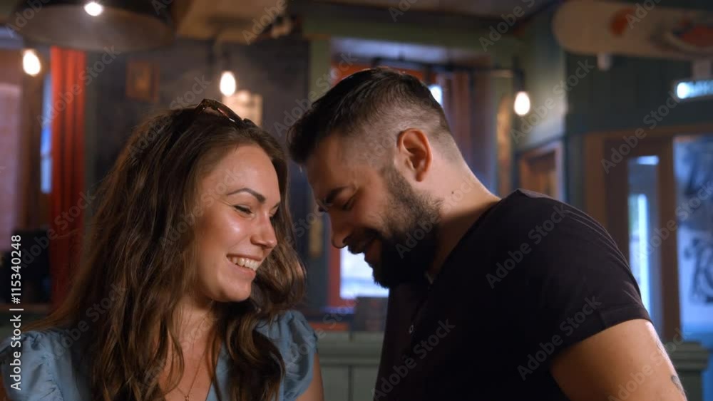 A girl and a boy sit at a bar A girl and a boy sit at a bar