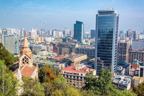View of downtown Santiago  Chile with a church and statue in the foreground