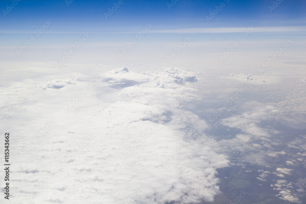 Clouds carpet blue skyand horizon from above Clouds carpet blue skyand horizon from above