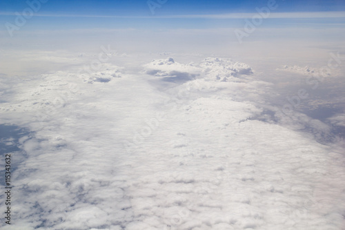 Clouds carpet blue skyand horizon from above © disq
