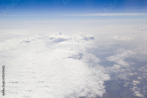 Clouds carpet blue skyand horizon from above