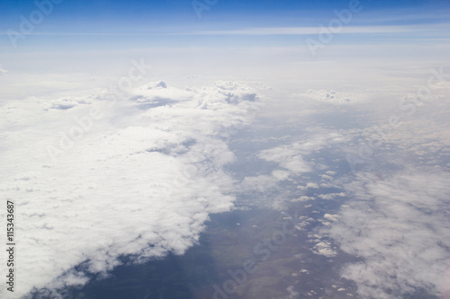 Obraz na plátne Clouds carpet blue skyand horizon from above