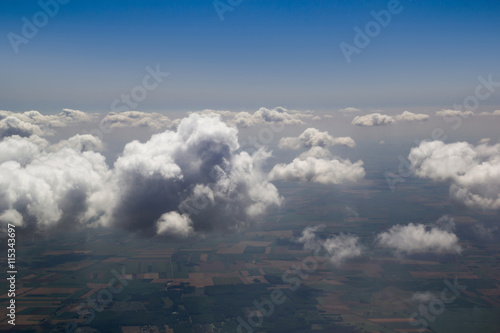 Foto Clouds blue sky ground and horizon from above