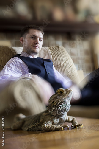 Pagona Bearded Dragon posing with male owner or zoologist photo