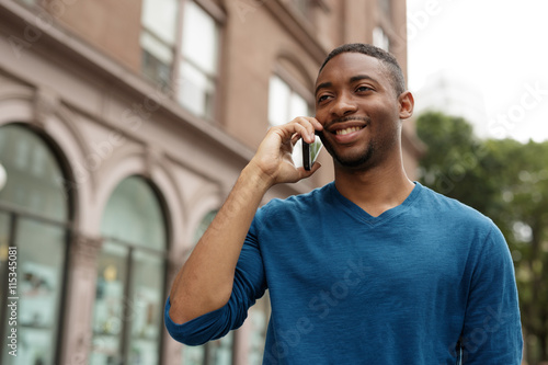 Young man in city talking on cell phone