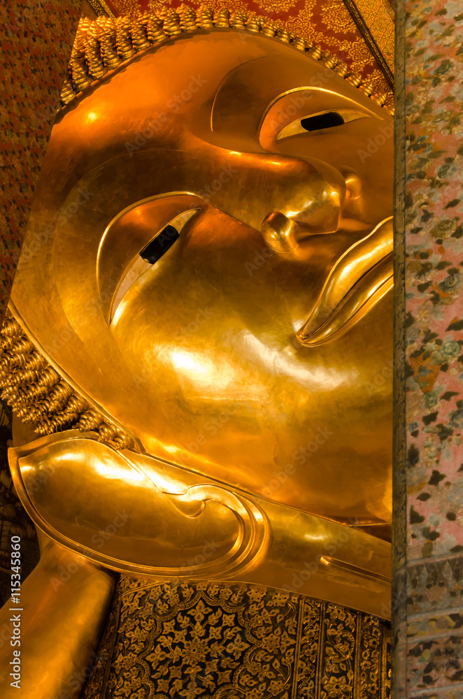Face of The Golden Reclining Buddha Statue of Wat Pho Monastery In Bangkok, Thailand.