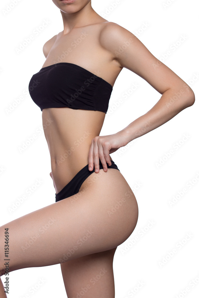 Fototapeta premium perfect body of fitness woman in black lingerie isolated on white. hands on waist