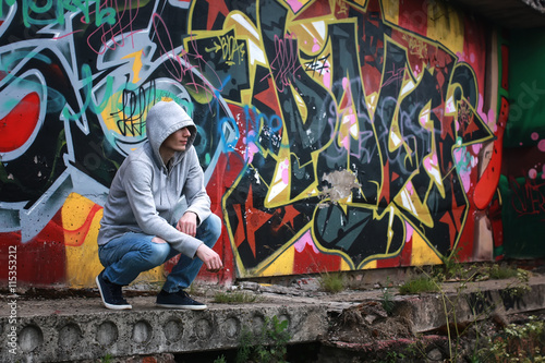man in hoody draw graffiti