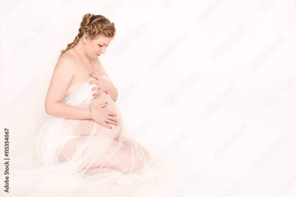 Happy pregnant woman sitting on white background Happy pregnant woman sitting on white background