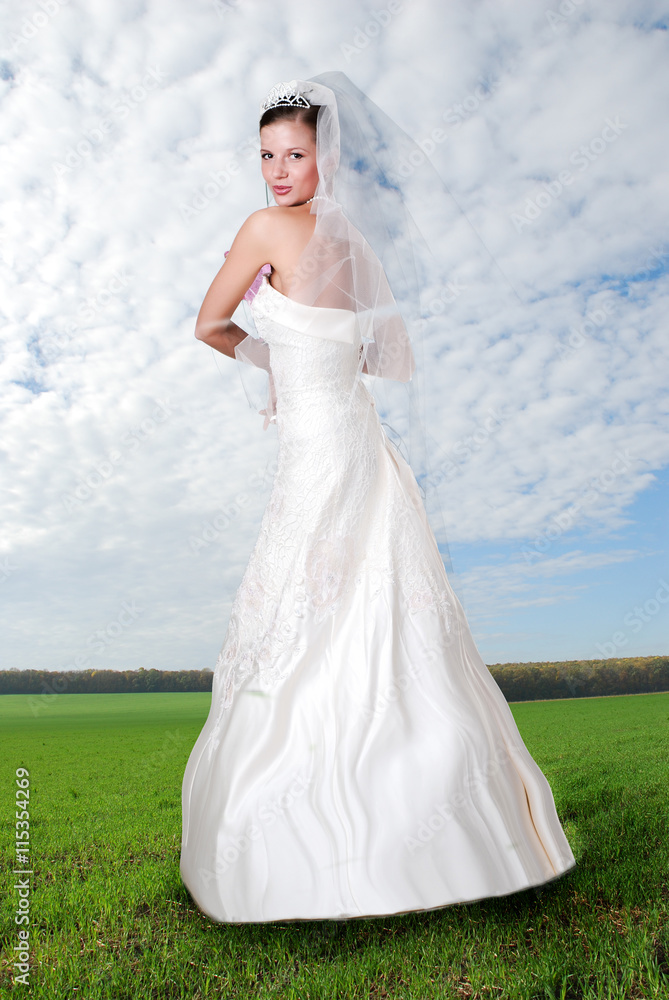 young bride and cloudy sky
