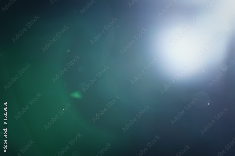 real green lens flare over dark background real green lens flare over dark background