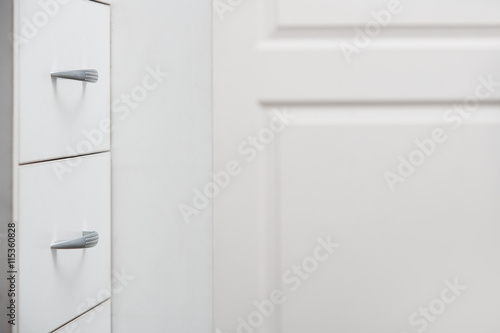 Cabinet with sliding trays and chrome handles