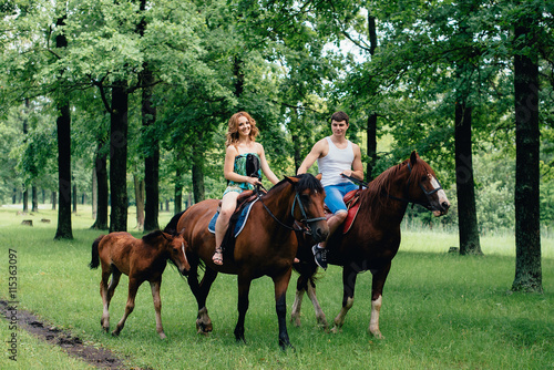 Lovers ride horses in the park