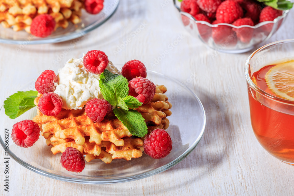 Waffles garnished with mascarpone and raspberries. Waffles garnished with mascarpone and raspberries.
