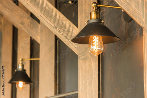 old-fashion lamp hanging on wooden wall