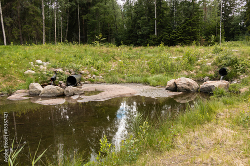Streaming water in a buffer pond at a water treatment wetland in Finland