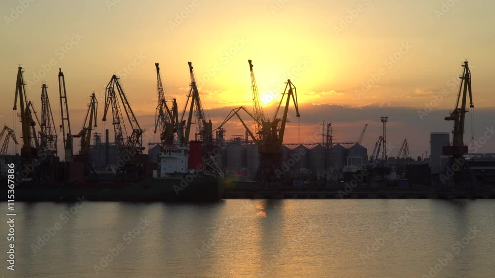 Sunset on a background of cranes at the port Sunset on a background of cranes at the port