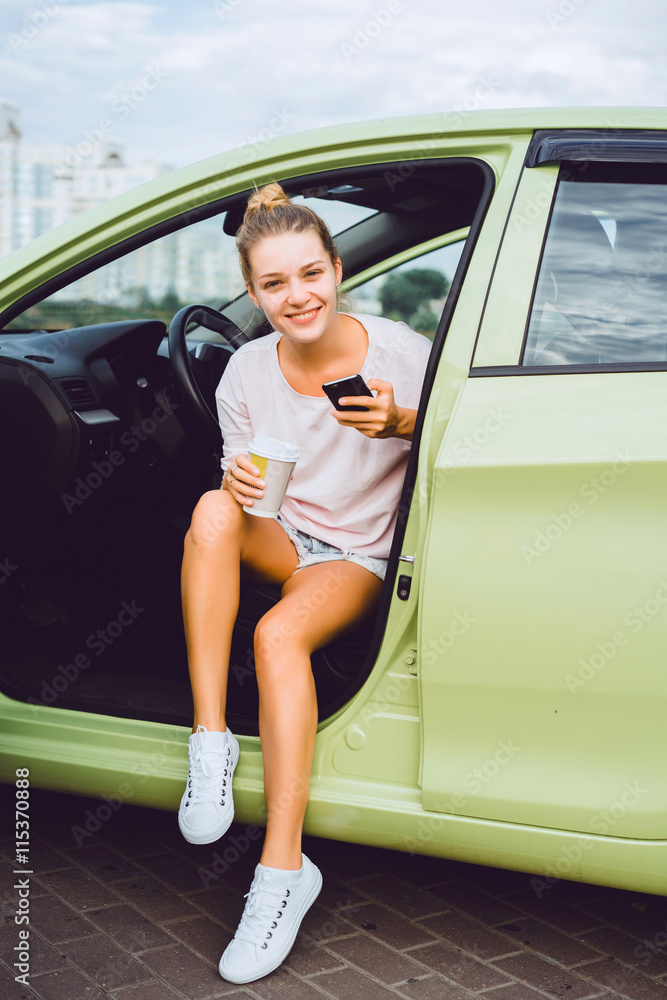 young pretty woman posing on the car, call phone, using smartphone, happy face, smile, outdoor portrait, hipster style young pretty woman posing on the car, call phone, using smartphone, happy face, smile, outdoor portrait, hipster style