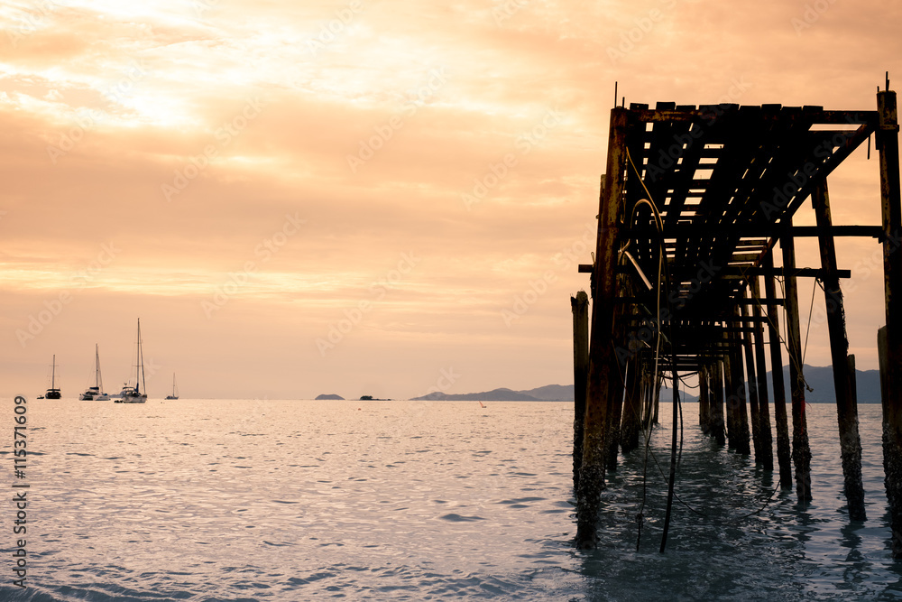 sea and wood bridge with sunset in evening, with vintage tone and copy sppace sea and wood bridge with sunset in evening, with vintage tone and copy sppace