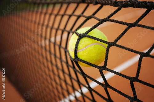 Tennis ball in the net   © yossarian6