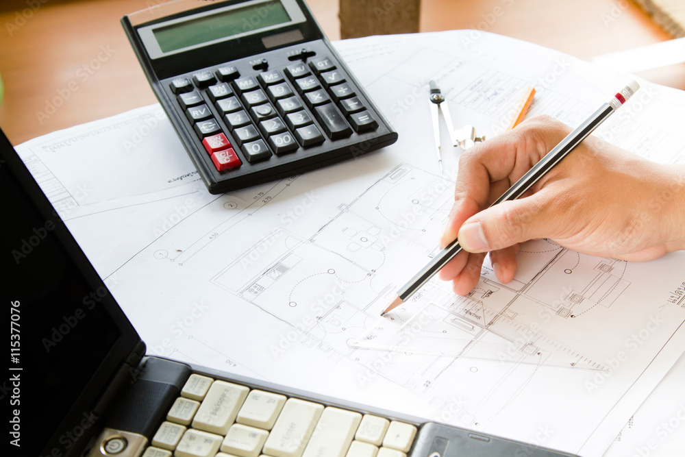 Architect working on blueprint, hand using pencil design blueprint Architect working on blueprint, hand using pencil design blueprint