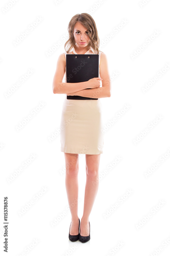 Young attractive brunette woman in a business suit with a folder for papers posing in studio isolated on white background. Young attractive brunette woman in a business suit with a folder for papers posing in studio isolated on white background.
