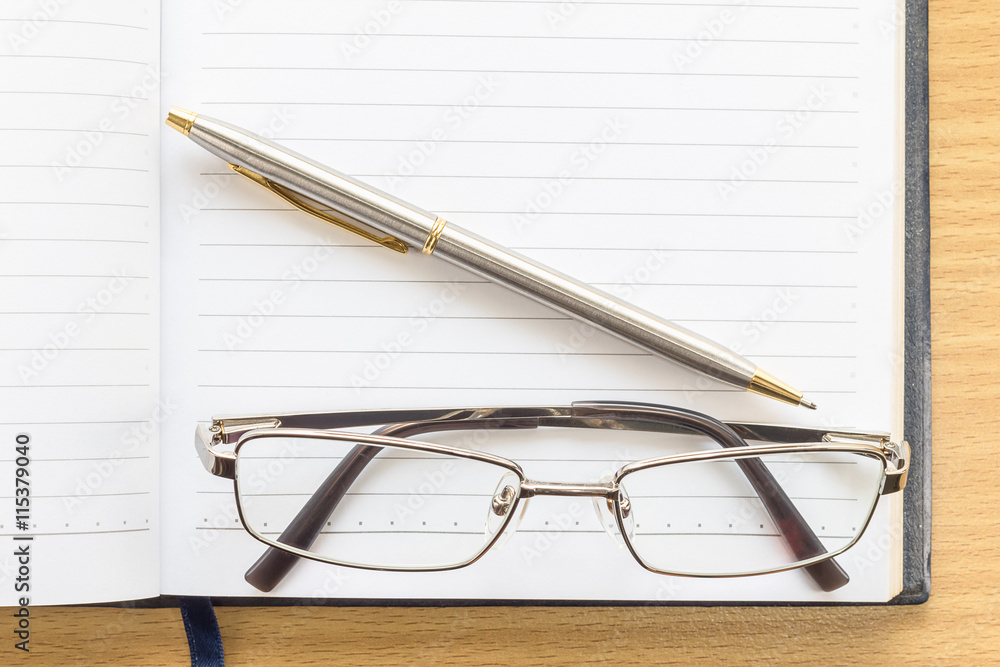 Notebook open blank page and Eyeglasses Notebook open blank page and Eyeglasses