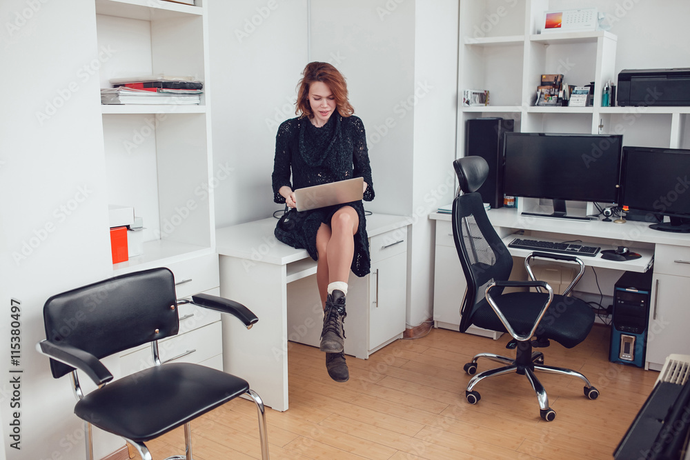 Young business woman with a computer in the office Young business woman with a computer in the office