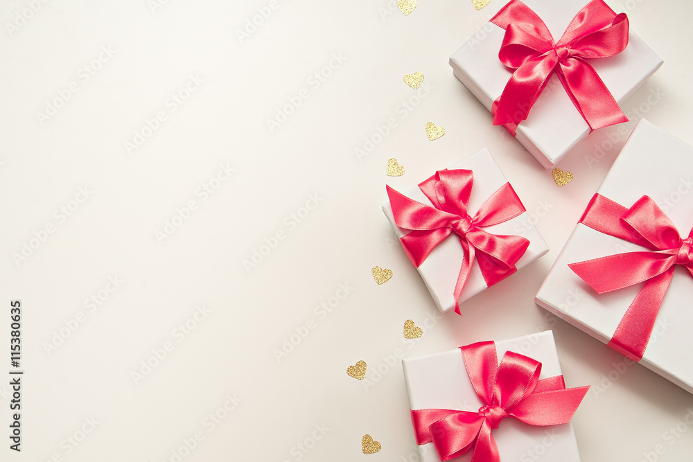 four gift boxes with pink ribbon four gift boxes with pink ribbon