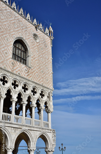 Doge Palace corner with gothic gallery and beautiful sky photo