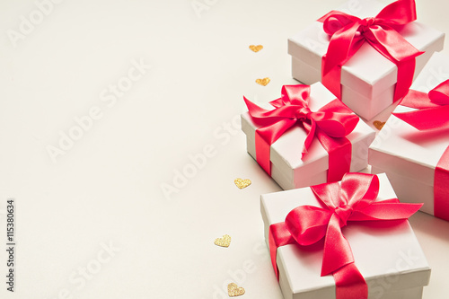 four gift boxes with pink ribbon