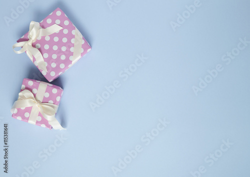Pink presents on a baby blue background forming a page border © beckystarsmore