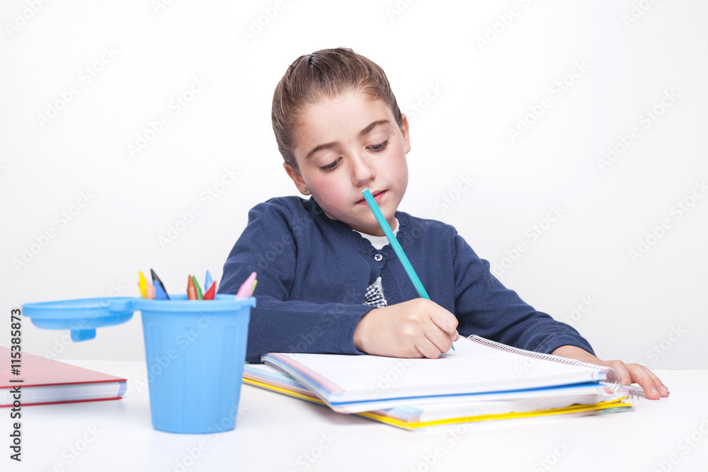 Cute little girl drawing with multicolored pencils Cute little girl drawing with multicolored pencils