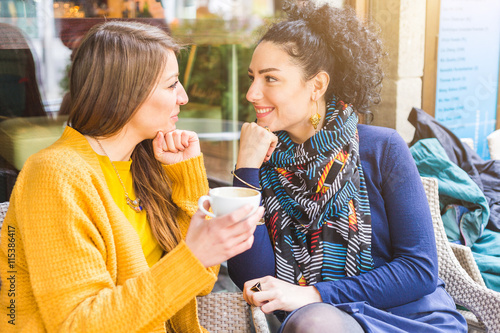 Photography Lesbian couple talking and cuddling at a cafe