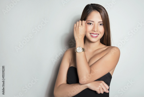 beautiful young asian woman with long hair posing with wrist watch