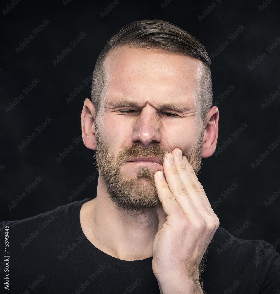 Toothache. Portrait of a man with face closed by hand. Toothache. Portrait of a man with face closed by hand.