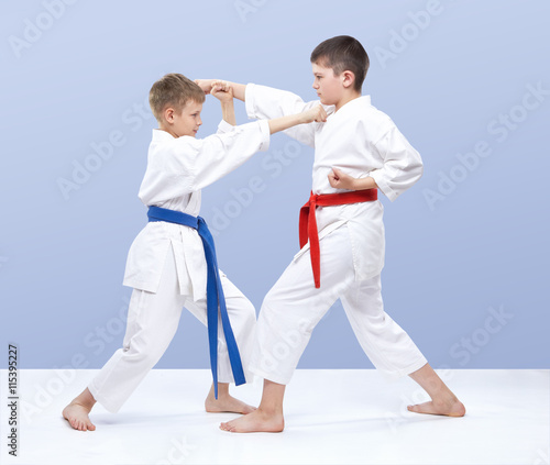 The boys are training strikes and blocks of hands
