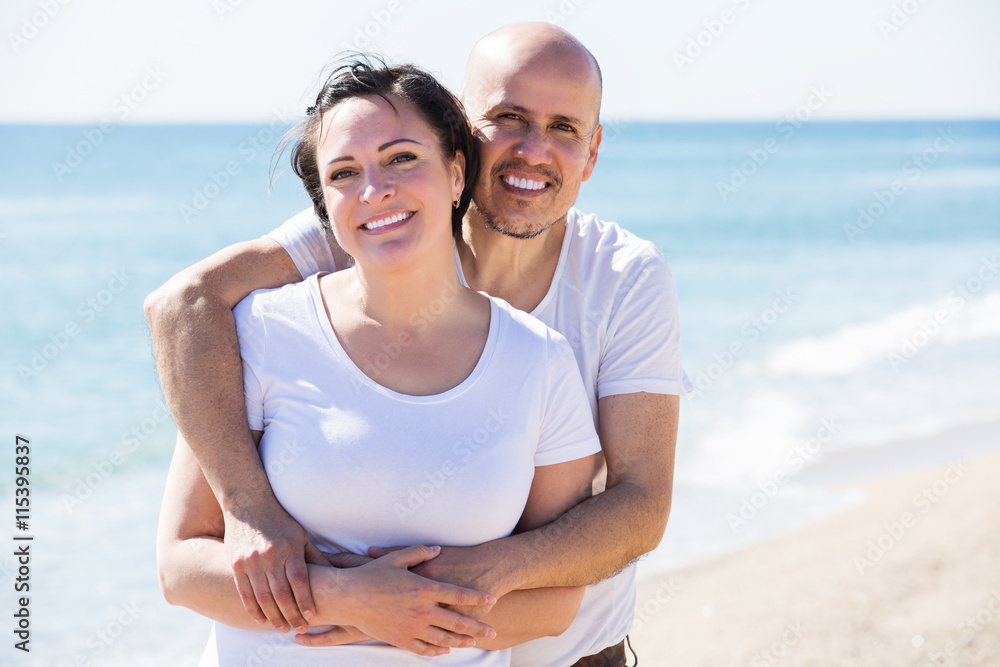 Fototapeta premium Couple embracing on the beach