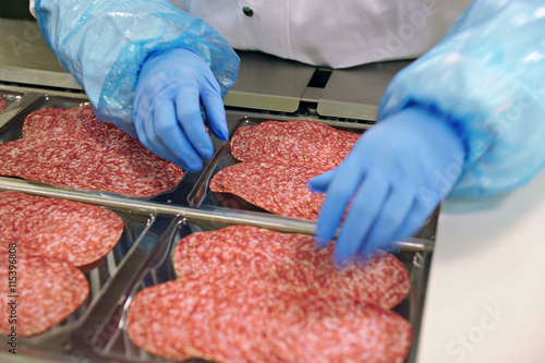 Close-up of industrial salami production process in protective atmosphere