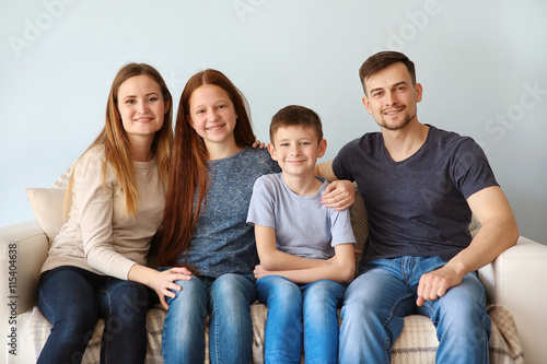 Happy family sitting on sofa