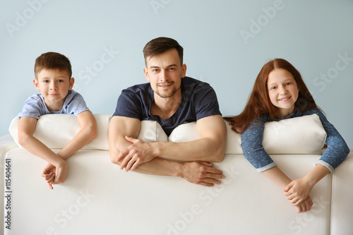 Happy family sitting on sofa