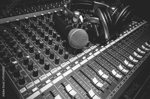 Music instruments the microphone and headphones on sound mixer.