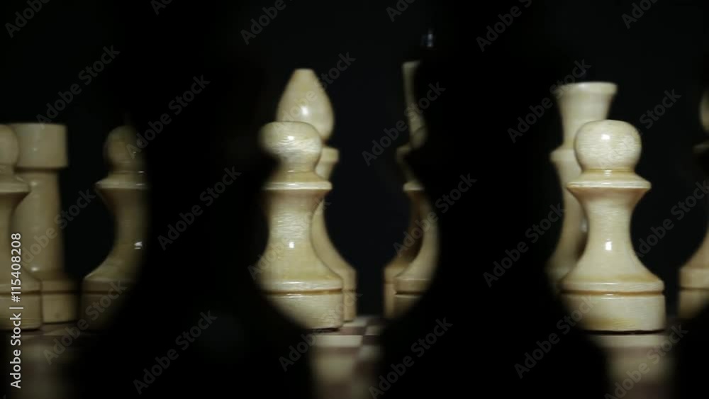 Chessboard and chess pieces in dark room closeup Chessboard and chess pieces in dark room closeup